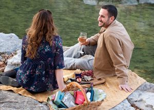 Couple enjoy a picnic with Delysia chocolate truffles on the side